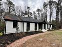 White brick ranch house with black accents, brick walkway at 72 Beverly Dr, Durham, NC 27707