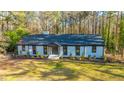 Beautifully landscaped home with brick and black trim with a lush green yard at 72 Beverly Dr, Durham, NC 27707