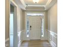 Bright foyer featuring a stylish front door with sidelights and classic wainscoting for an elegant touch at 82 N Stagecoach Dr, Wendell, NC 27591