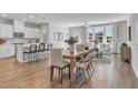 Open concept kitchen with island, white cabinets, and hardwood floors at 8947 Kennebec Crossing Dr # 53, Angier, NC 27501