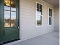 Close-up of the entryway showcasing a stylish front door and windows at 116 Bearwallow Forest Way, Wendell, NC 27591
