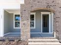Close up of a brick archway and entry door with sidelight window at 121 Big Bradley Way, Wendell, NC 27591