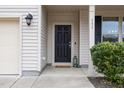 Front door entry with black door and lantern-style lights at 131 Kinnakeet Dr, Durham, NC 27704
