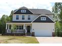 Two-story house featuring gray and white siding, a front porch, and a two-car garage at 1334 Reading Ct # 48Kl, Burlington, NC 27217