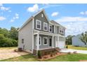 Side view of a modern two-story home with gray siding and a well-maintained lawn at 139 Grove Township Way, Angier, NC 27501