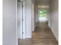 Bright hallway with neutral walls and flooring leads to a spacious living area and outdoor deck at 139 Grove Township Way, Angier, NC 27501