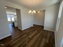 View of dining room with wood floors open to kitchen and adjoining spaces at 140 Wild Turkey Way, Lillington, NC 27546