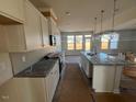 Modern kitchen featuring granite countertops and an island at 140 Wild Turkey Way, Lillington, NC 27546