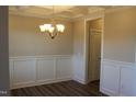Formal dining room with wainscoting and chandelier at 1410 Reading Ct # 92Kl, Burlington, NC 27217