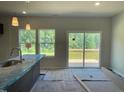Bright dining area with sliding glass doors leading to a wooden deck and scenic views at 157 Grove Township Way, Angier, NC 27501
