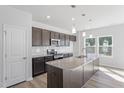 Bright kitchen showcasing stainless steel appliances, granite countertops, and modern fixtures at 157 Grove Township Way, Angier, NC 27501