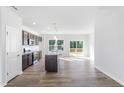 Modern kitchen featuring stainless steel appliances, dark cabinetry, and an island with a granite countertop at 157 Grove Township Way, Angier, NC 27501