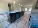 Modern kitchen featuring a large island, stainless steel appliances, and an open layout at 157 Grove Township Way, Angier, NC 27501