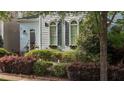 Charming two-story home with arched windows, shutters, and lush landscaping at 1703 Happiness Hill Ln, Raleigh, NC 27614
