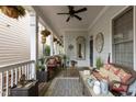 Inviting front porch with ample seating and charming decor, perfect for relaxation at 1703 Happiness Hill Ln, Raleigh, NC 27614