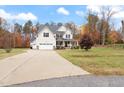 Beautiful two-story home with an attached two-car garage and a long driveway in a country setting at 1726 Rapids Ct, Franklinton, NC 27525
