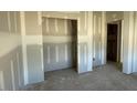 Bedroom with alcove and closet featuring doors and baseboards at 173 Grove Township Way, Angier, NC 27501