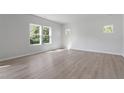 Bright, empty bedroom with neutral walls, wood floors, and large windows with natural light at 173 Grove Township Way, Angier, NC 27501