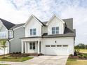 Elegant two-story home boasting a white exterior, prominent gables, and a convenient attached garage at 1813 Bright Lantern Way, Wendell, NC 27591