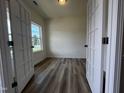 Bright bedroom with wood-look floors and a large window, offering a serene atmosphere at 19 E American Marigold Dr # 34, Benson, NC 27504
