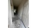 Hallway with concrete flooring and white trim detailing leads to various rooms in the home at 19 E American Marigold Dr # 34, Benson, NC 27504