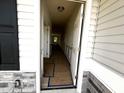 Bright hallway with white wainscoting, neutral walls, and visible doorways to other rooms at 19 E American Marigold Dr # 34, Benson, NC 27504