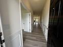 Inviting hallway with wood-look flooring and stylish trim, leading to the living area at 19 E American Marigold Dr # 34, Benson, NC 27504