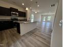 Modern kitchen with dark cabinets, granite countertops, stainless steel appliances and open to the living area at 19 E American Marigold Dr # 34, Benson, NC 27504