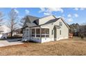 Side view of a two-story house with stone and shingle exterior and a front porch at 20 Wes Sandling Rd, Franklinton, NC 27525