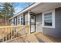 Wooden deck with gray siding and security door at 2041 Grassy Creek Virgilina Rd, Oxford, NC 27565