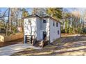 Two-story house with gray siding, a dark garage door, and a wooden deck at 2513 Rochelle St, Durham, NC 27703