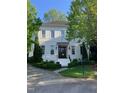 Stunning two-story white brick home with lush landscaping and a manicured lawn at 2900 Glenanneve Pl, Raleigh, NC 27608