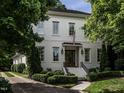 Well-maintained two-story brick home with manicured landscaping, a charming entryway, and a paved driveway at 2900 Glenanneve Pl, Raleigh, NC 27608