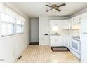 Bright kitchen featuring white cabinets and tile floor at 301 King Arthur Trl, Garner, NC 27529