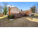 Home features a deck, grassy backyard, and shed at 307 E Jackson St, Mebane, NC 27302