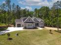 Charming two-story home with gray siding, a well-manicured lawn, and a long driveway at 3925 Cedar Knolls Dr, Youngsville, NC 27596