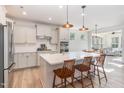 Modern kitchen featuring an island with barstool seating, stainless steel appliances, and pendant lighting at 40 Ironwood Blvd, Youngsville, NC 27596