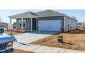 Gray house with white garage door and landscaping at 441 White Birch Ln, Angier, NC 27501