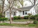 A charming home with beautiful landscaping and mature trees surrounding the property at 504 Washington St, Raleigh, NC 27605
