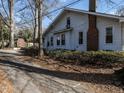 Home exterior features a brick chimney, an attached carport and a partial driveway at 504 Washington St, Raleigh, NC 27605