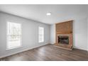 Living room with brick fireplace and hardwood floors at 5321 Baywood Forest Dr, Knightdale, NC 27545