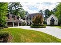 House exterior with a three-car garage and a circular driveway at 805 Pinehurst Dr, Chapel Hill, NC 27517