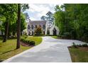 House exterior with a long driveway and lush landscaping at 805 Pinehurst Dr, Chapel Hill, NC 27517