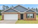 Two-car garage and front door at 858 Forth Ct, Gibsonville, NC 27249