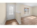Bright foyer featuring a decorative glass front door and hardwood floors at 1219 Carlton Ave, Burlington, NC 27217