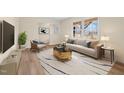 Sun-filled living room featuring contemporary furniture, hardwood floors, and large windows at 1219 Carlton Ave, Burlington, NC 27217