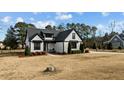Two-story home with white siding and black accents, in a quiet neighborhood at 15 Willow Bend Dr, Youngsville, NC 27596