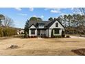 Charming farmhouse exterior, showcasing a manicured lawn and mature trees at 15 Willow Bend Dr, Youngsville, NC 27596