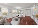 Bright dining room with hardwood floors, stylish white chairs and abundant natural light at 1700 Cary Reserve Dr, Cary, NC 27519