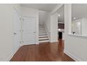 Bright foyer featuring hardwood floors, staircase, and a glimpse of the kitchen at 1700 Cary Reserve Dr, Cary, NC 27519